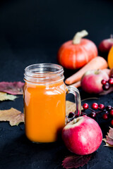 Halloween cocktail, pumpkin orange drink with spices. Dark vintage dirty background. Creative atmospheric decoration