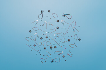 Silver details earrings accessories jewelry hand made soft focus blue background.