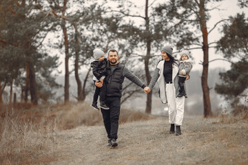 Family with cute little child. Father in a black jacket. People have fun in a spring forest