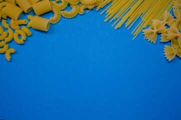 different pasta on a blue background.