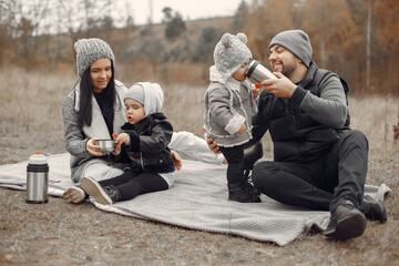 Family with cute little child. Father in a black jacket. People have fun in a spring forest