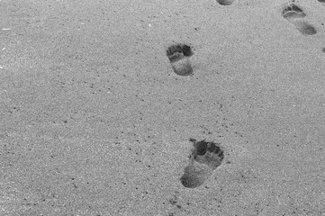 Top view, footprints on the wet sand of the Turkish coast. Copy Space. Sea texture. Summer background. Quarantine. Self-isolation.