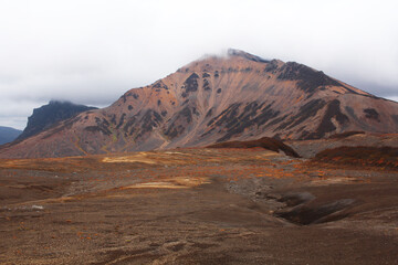 Hills, mountains and autumnal tundra, colored orange and red