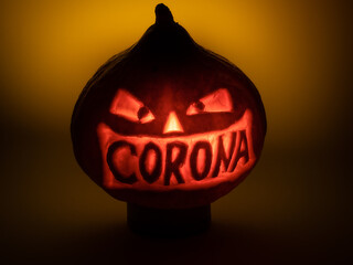 Halloween pumpkin with corona lettering glowing in the dark