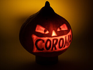 Halloween pumpkin with corona lettering glowing in the dark