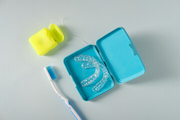 Plastic aligners for teeth straightening, toothbrush, floss