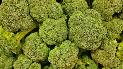 Fresh green Broccoli florets closeup for sale in a traditional vegetable market.