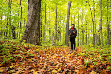 Active healthy man hiking in beautiful autumn forest