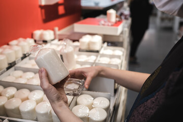 Young lady in a mask shopping at the grocery store for celebration and authentic decor.