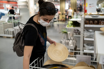 young masked lady who buys decor for her home and room.