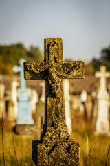 Statue of antique cross with the crucified Christ on the old 19th century cemetery. Ukraine