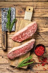 Raw picanha or  Top Sirloin Cap steak on a chopping Board. wooden background. Top view