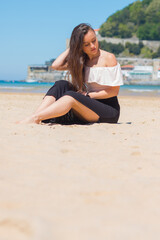 Fototapeta na wymiar Young caucasian girl posing at La Concha bay in Donostia-San Sebastian; Basque Country.