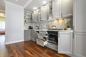 Closeup details of grey and white modern classic kitchen, all doors are open