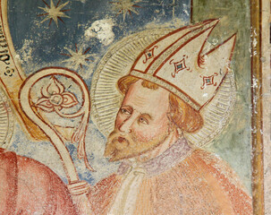 San Biagio Vescovo; particolare di affresco esterno della chiesa romanica di San Vigilio a Morter;...