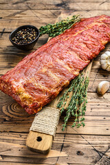 Smoked pork ribs on a chopping Board. Wooden background. Top view