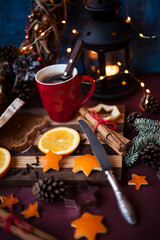 Christmas  and New Year preparations,serving table,hot coffee in the mug,christmas pie,fruits on the cutting board. holiday mood 