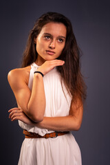 Young girl with a nice dress posing at a photography studio.