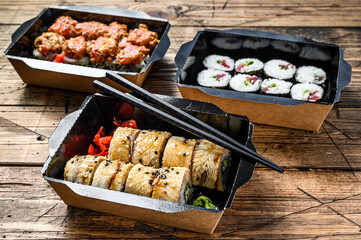 Japanese restaurant food in take away, set delivery box.  Wooden background. Top view