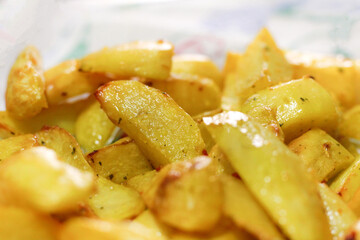 Fried and delicious potatoes served on a white plate