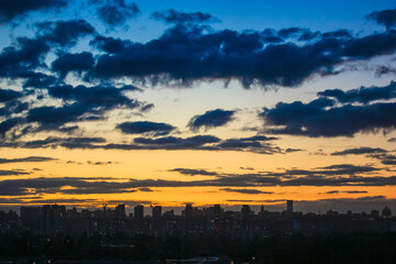 Beautiful sunset and clouds in the sunset orange and blue sky, big city view