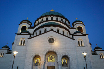 Fototapeta na wymiar The Church of Saint Sava is seen backgrounded by a clear blue sky during a autumn evening in the city of Belgrade, Serbia.