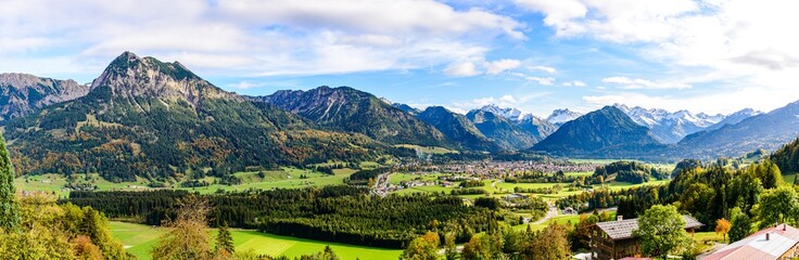 Fototapeta na wymiar Panorama on Obersdorf in Allgau, Bavaria, Bayern, Germany. Rubihorn, Nebelhorn, Big Klottenkopf, alps in Tyrol, Vorarlberg, Mountains of good hope, blue sky, Rotgrundspitze, Rappenseekopf, Austria.
