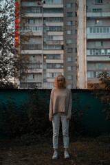 Young girl on the background of a residential building
