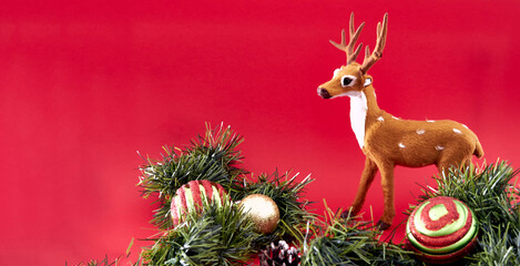 The isolated reindeer on the red background for design as the object of the new year and the Santa...