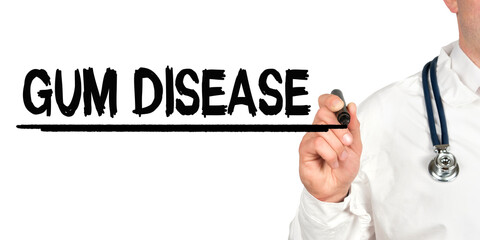 Doctor writes the word - GUM DISEASE. Image of a hand holding a marker isolated on a white background.