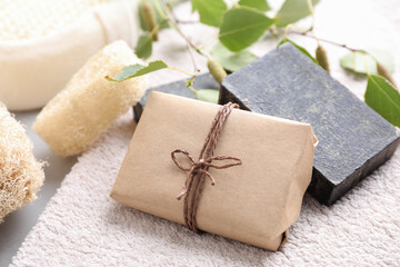 Fototapeta na wymiar Natural tar soap on soft towel, closeup