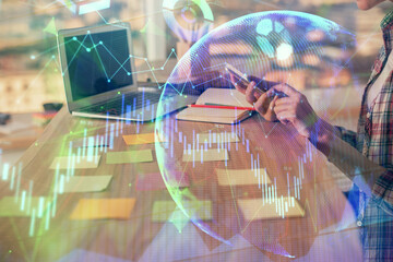 Double exposure of woman hands working on computer and forex graph hologram drawing. Financial analysis concept.