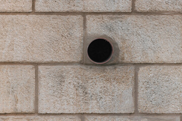 Round hole in the wall. Downpipe from the wall in Israel. Round pipe sticking out of the wall....