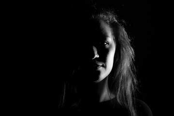 Black and white portrait of an Italian young woman on black background