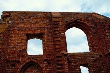 Ruins of a medieval church in Poland. Red brick wall.