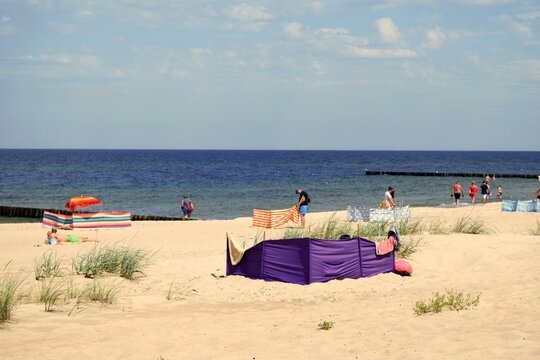 View of the Polish part of the Baltic Sea and the beach where tourists sunbathe.