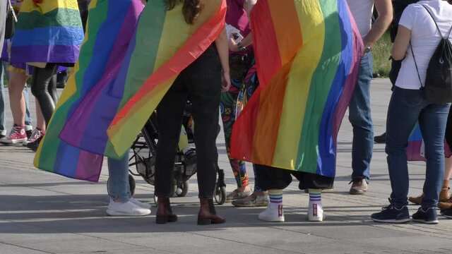 LGBTQ+ pride people wearing flags celebrating demonstration