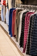 Obraz premium Stylish clothes on hangers in a store.