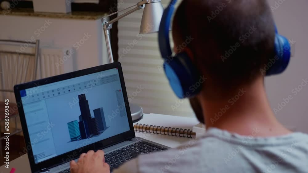 Poster architect looking at building model on laptop late night time in home office. industrial employee st
