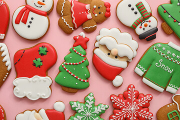 Fototapeta na wymiar Different Christmas gingerbread cookies on pink background, flat lay