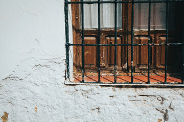 Old dusty window in the wall of a house.