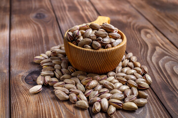 Pistachios in a Cup on a wooden background.  Nuts close up