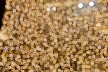 Defocused random shiny gold yellow blurred bokeh circle background wallpaper for festive season celebration