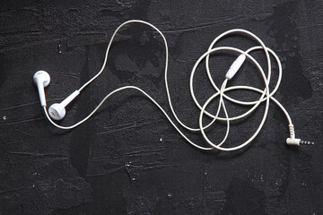 white headphones on a black background. view from above. accessories