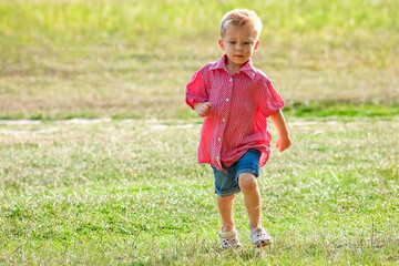 Happy child playing in nature in summer