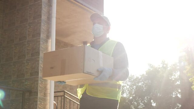 delivery pandemic coronavirus vaccine a goods and food product. courier delivery man covid delivers food to your home. parcel delivery concept. courier carries box warehouse coronavirus deliveryman