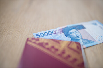 Corner of a Fifty Thousand Rupees Bill Partially Inside a Swedish Passport