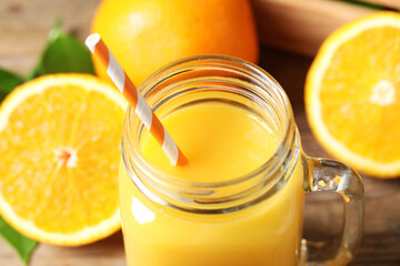 Mason jar of orange juice and fresh fruits, closeup