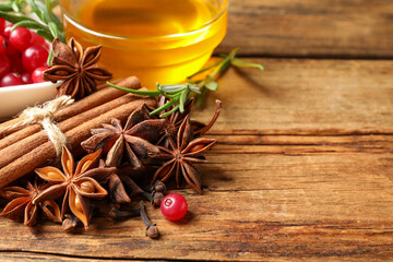 Composition with mulled wine ingredients on wooden table, closeup. Space for text