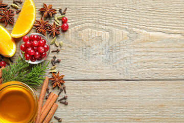 Flat lay composition with mulled wine ingredients on wooden table. Space for text